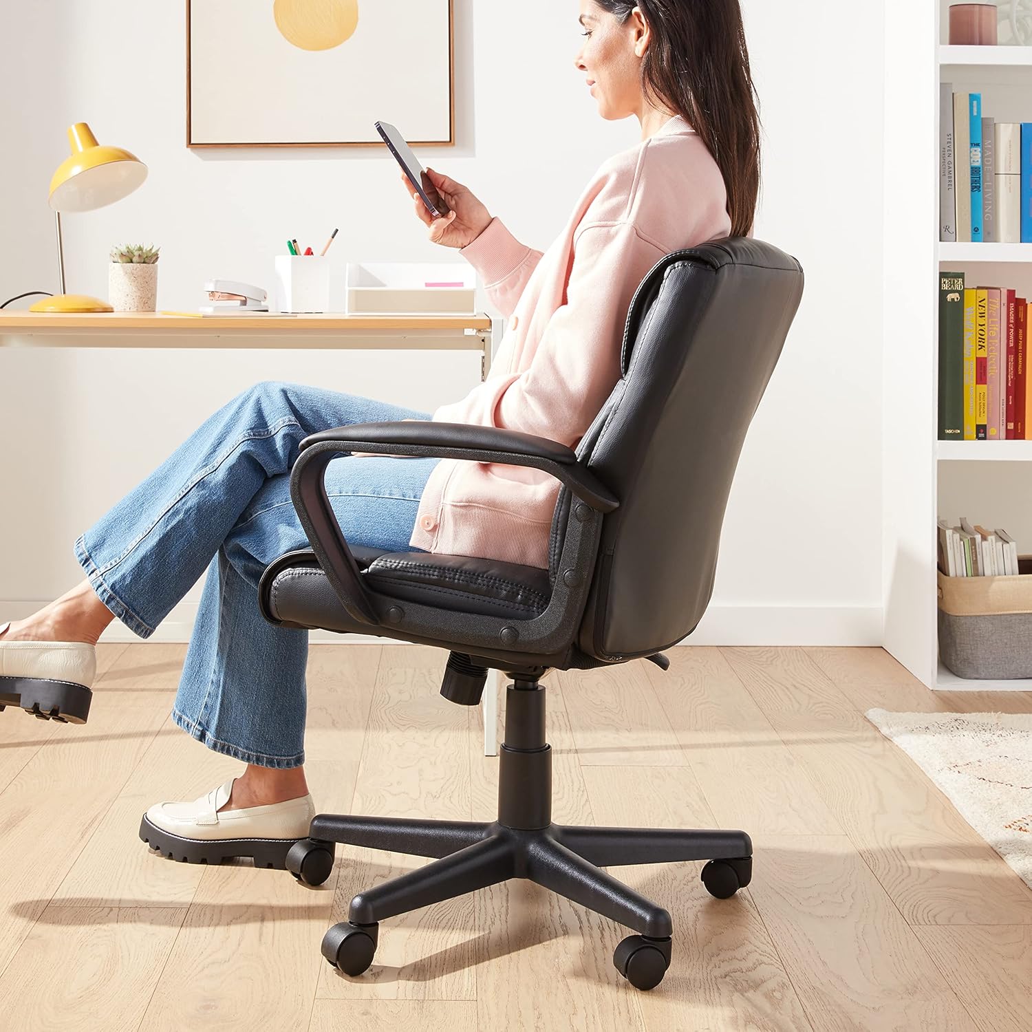 1761032899_Amazon-Basics-Office-Computer-Task-Desk-Chair-with-Padded-Armrests-Mid-Back-Adjustable-360-Swivel-Rolling-275-Pound-Capacity-24.2D-x-24W-x-34.8H-Black-Faux-Leather.jpg Amazon Basics Office Computer Task Desk Chair with Padded Armrests, Mid-Back, Adjustable, 360 Swivel, Rolling, 275 Pound Capacity, 24.2"D x 24"W x 34.8"H, Black Faux Leather - Image 3